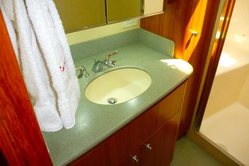 Slide: The Image of Bathroom vanity in 2006 Tiara 44' Sovran yacht with sink and towel. - 28