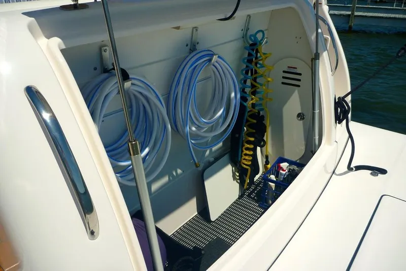 Slide: The Image of Storage compartment on a 2006 Tiara 44' Sovran yacht with coiled hoses and accessories. - 3