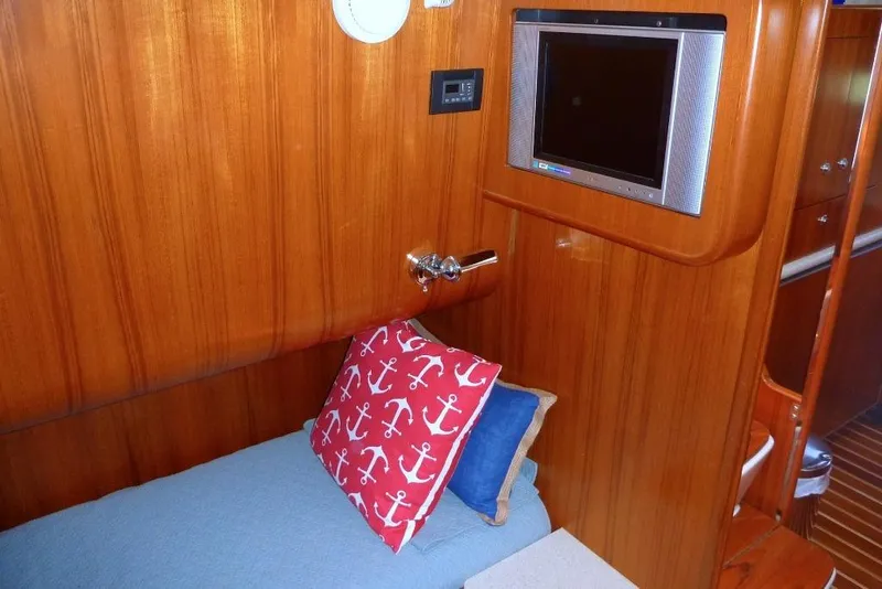 Slide: The Image of Cozy cabin interior of 2006 Tiara 44' Sovran yacht with TV and anchor-themed pillow. - 30