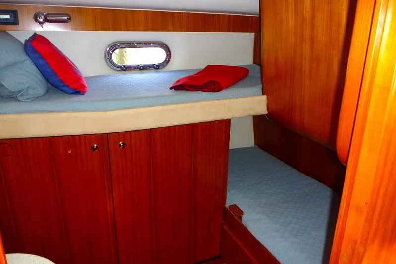 Slide: The Image of 2006 Tiara 44' Sovran yacht cabin with wooden interior and bunk beds. - 31