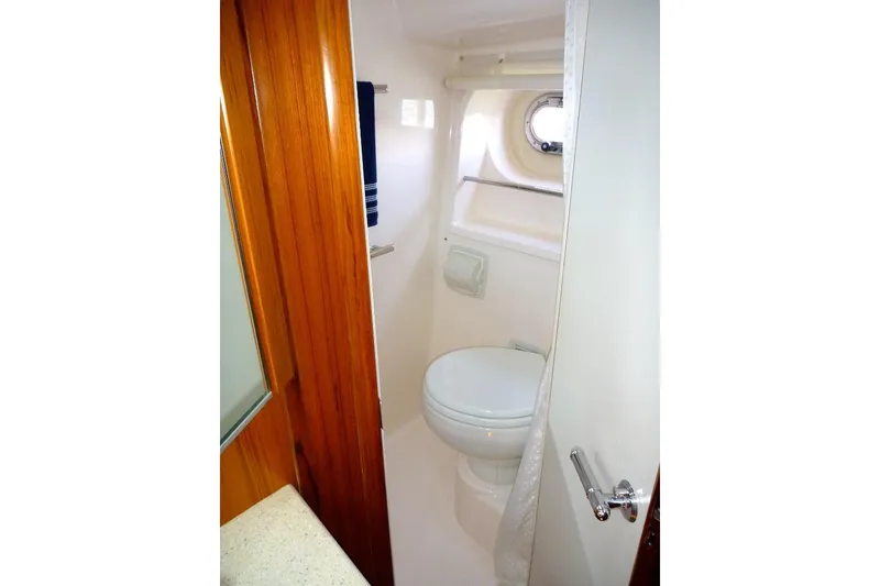 Slide: The Image of 2006 Tiara 44' Sovran yacht bathroom with wooden door and porthole window. - 32