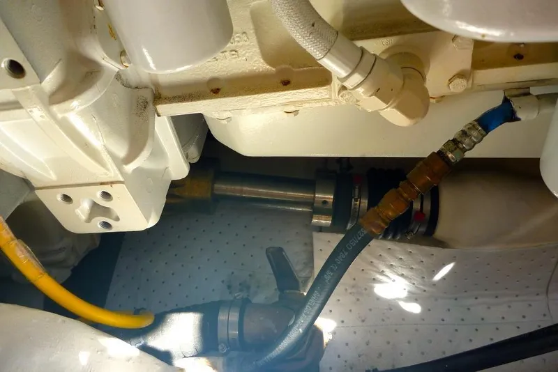 Slide: The Image of Engine compartment of a 2006 Tiara 44' Sovran boat, showing hoses and fittings. - 45