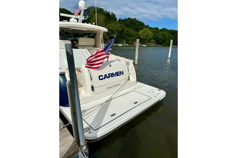 Slide: The Image of 2006 Tiara Yachts 4400 Sovran docked, displaying American flag and "Carmen" name. - 46