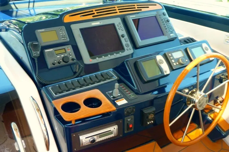 Slide: The Image of Helm of 2006 Tiara 44' Sovran yacht with advanced navigation equipment and wooden steering wheel. - 7