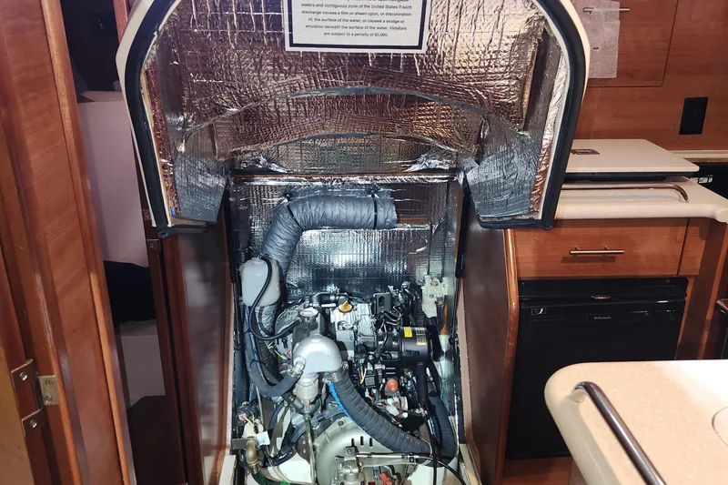 Slide: The Image of Engine compartment of a 2012 Hunter e 33 sailboat, featuring insulation and components. - 11
