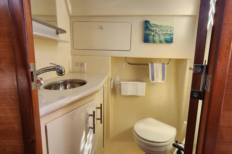Slide: The Image of 2012 Hunter e 33 yacht bathroom with sink, toilet, and motivational sign. - 21