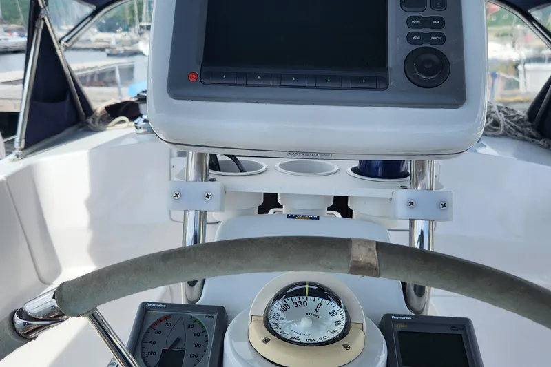 Slide: The Image of Cockpit of 2012 Hunter e 33 sailboat with navigation instruments and steering wheel. - 3