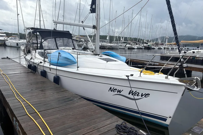 Slide: The Image of 2012 Hunter e 33 sailboat "New Wave" docked at marina with overcast sky. - 6