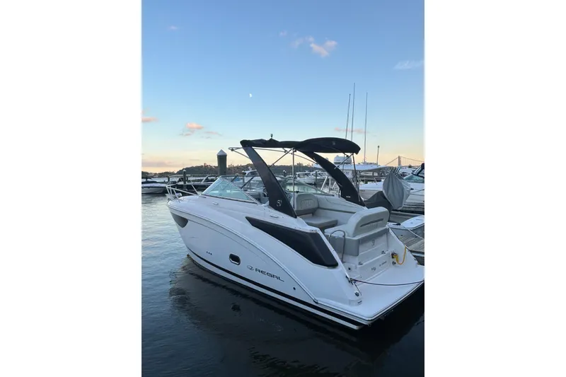Slide: The Image of 2021 Regal 26 Express boat docked at marina during sunset. - 1