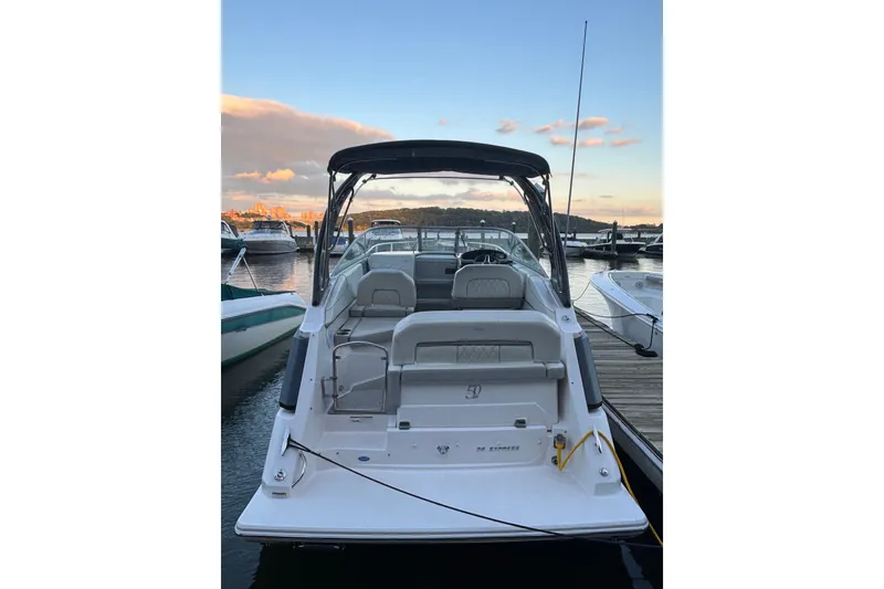 Slide: The Image of 2021 Regal 26 Express boat docked at marina during sunset. - 2