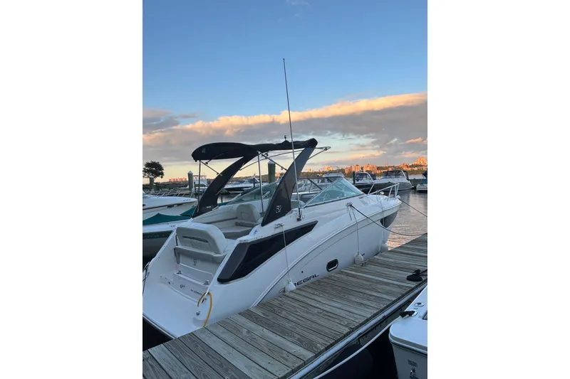 Slide: The Image of 2021 Regal 26 Express boat docked at marina during sunset. - 3