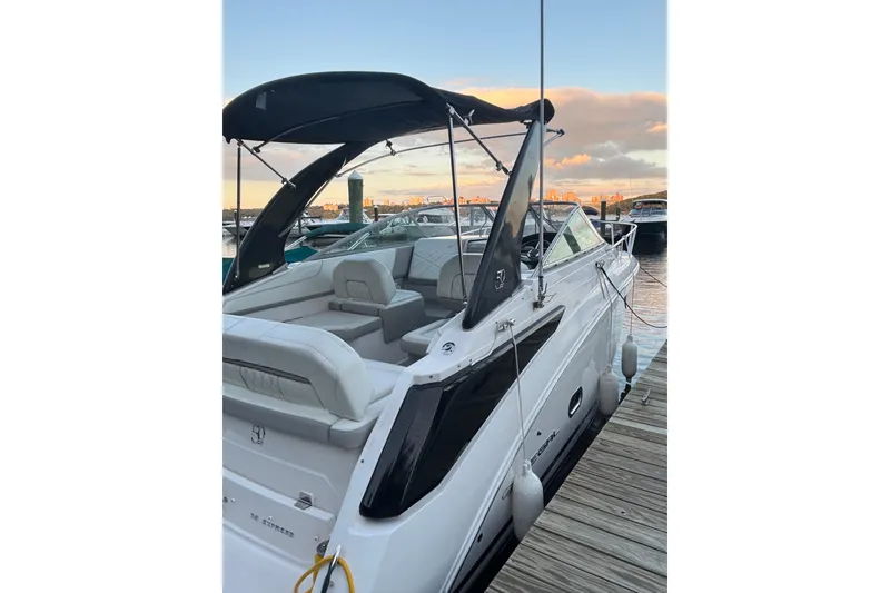 Slide: The Image of 2021 Regal 26 Express boat docked at sunset, featuring sleek design and comfortable seating. - 4