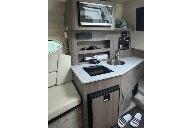 Slide: The Image of Compact kitchen area in 2021 Regal 26 Express boat with modern amenities. - 6