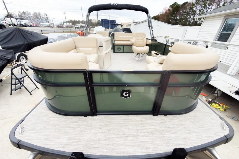 Slide: The Image of 2026 Godfrey Sweetwater Xperience 20' pontoon boat with beige seating and green exterior. - 2