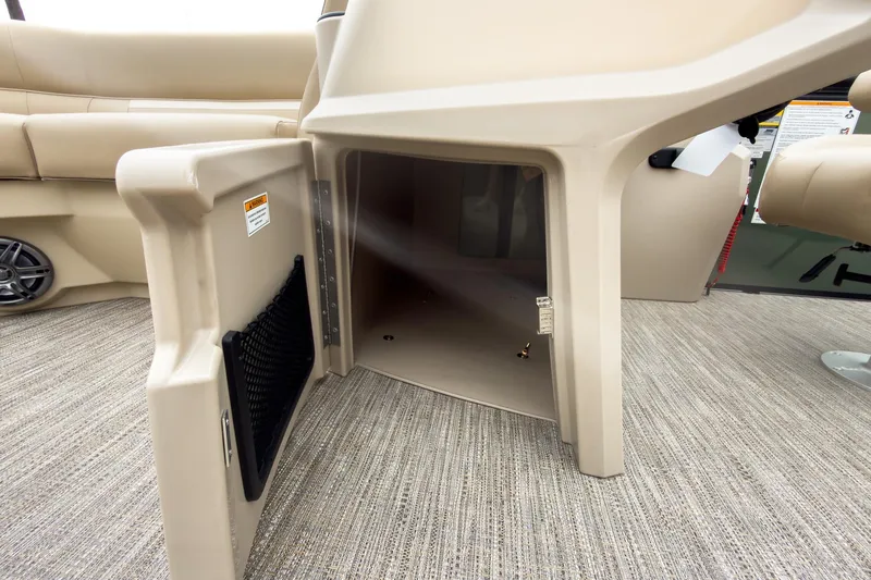 Slide: The Image of 2026 Godfrey Sweetwater Xperience 20' pontoon storage compartment with beige interior and carpeted flooring. - 23