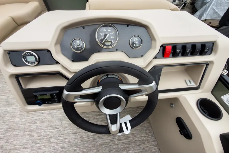 Slide: The Image of Steering console of 2026 Godfrey Sweetwater Xperience 20' Pontoon, featuring gauges and controls. - 8