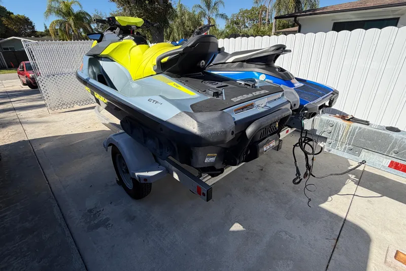Slide: The Image of 2021 Sea-Doo GTI SE 130 jet ski on trailer, parked in driveway. - 11