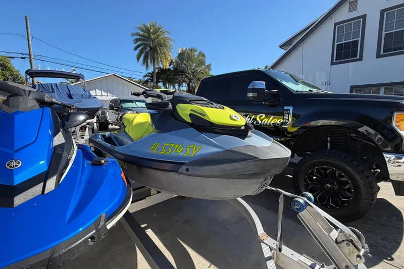 Slide: The Image of 2021 Sea-Doo GTI SE 130 jet ski on trailer, parked beside a truck. - 13