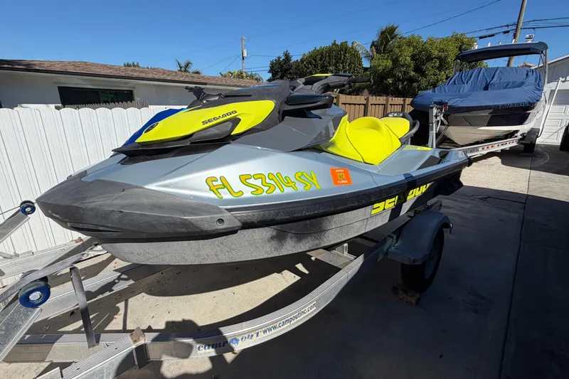 Slide: The Image of 2021 Sea-Doo GTI SE 130 jet ski on trailer, parked outdoors. - 14