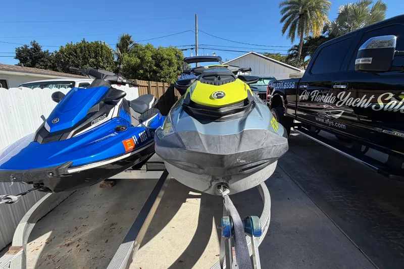 Slide: The Image of 2021 Sea-Doo GTI SE 130 jet ski parked beside a blue watercraft and a black truck. - 15