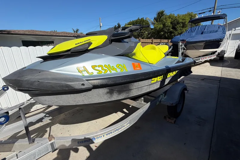 Slide: The Image of 2021 Sea-Doo GTI SE 130 jet ski on trailer, parked outdoors. - 16
