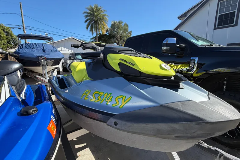 Slide: The Image of 2021 Sea-Doo GTI SE 130 jet ski parked outdoors, with vibrant yellow accents. - 18