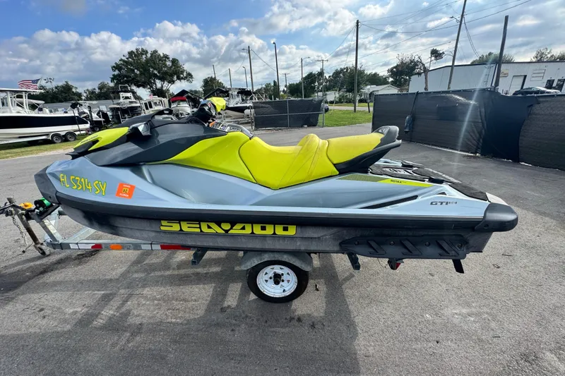 Slide: The Image of 2021 Sea-Doo GTI SE 130 jet ski with yellow seat on a trailer. - 4