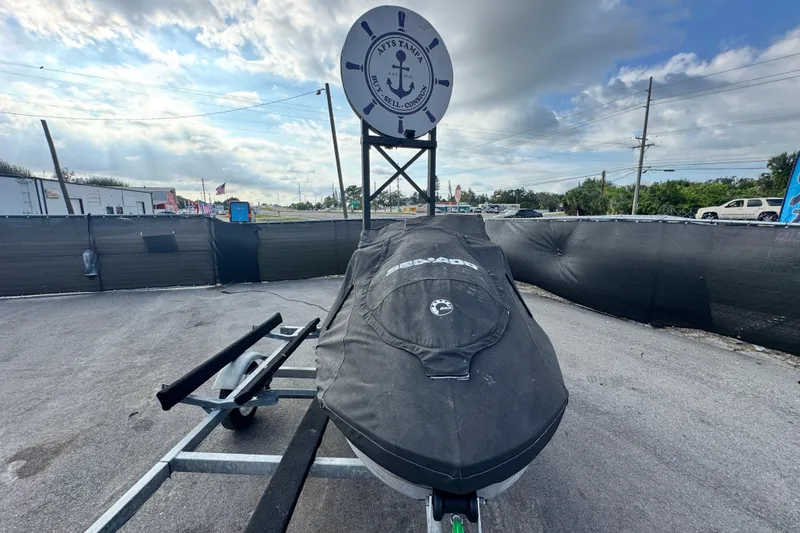 Slide: The Image of 2021 Sea-Doo GTI SE 130 covered on trailer, outdoor display with cloudy sky. - 6