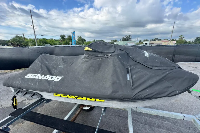 Slide: The Image of 2021 Sea-Doo GTI SE 130 covered on trailer, parked outdoors under cloudy sky. - 7
