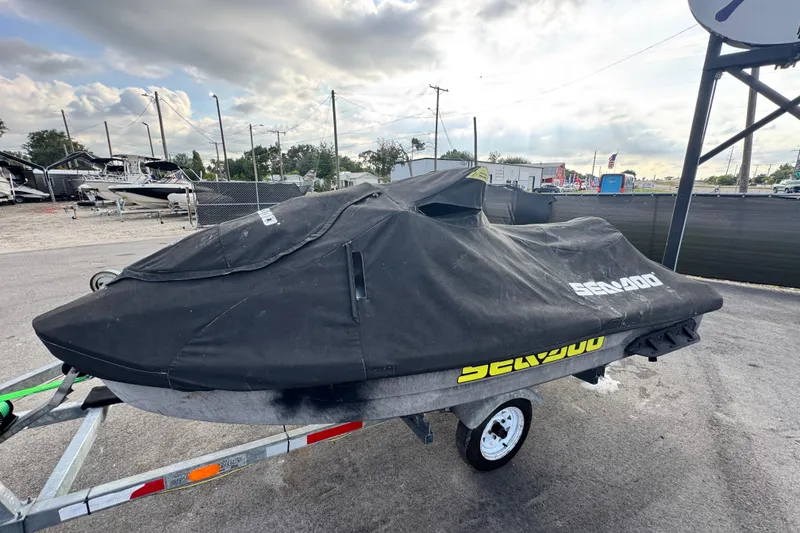 Slide: The Image of 2021 Sea-Doo GTI SE 130 jet ski covered, parked on a trailer outdoors. - 8
