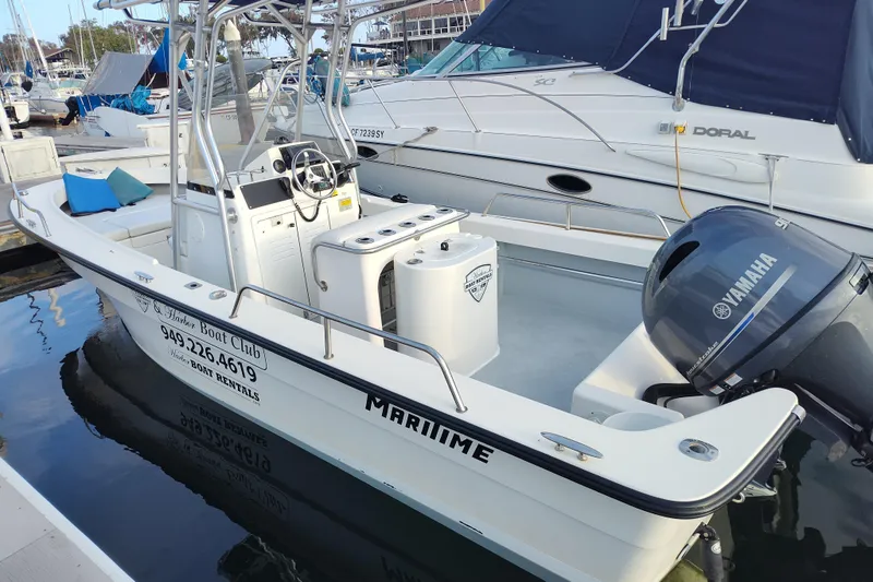 Slide: The Image of 2022 Duffy Bay Island boat docked, featuring Yamaha outboard motor and rental contact details. - 10