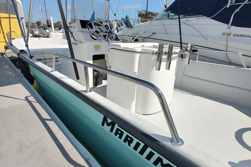 Slide: The Image of 2022 Duffy Bay Island boat docked, featuring steering console and seating area. - 8