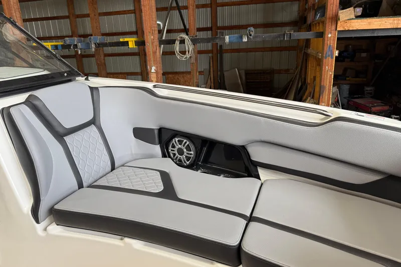 Slide: The Image of 2026 Yamaha Boats 255XE interior with sleek gray seating and speaker system. - 7