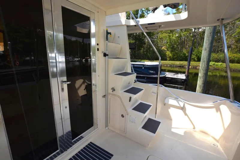 Slide: The Image of 2004 Mainship 400 Trawler boat deck with stairs and glass door. - 10