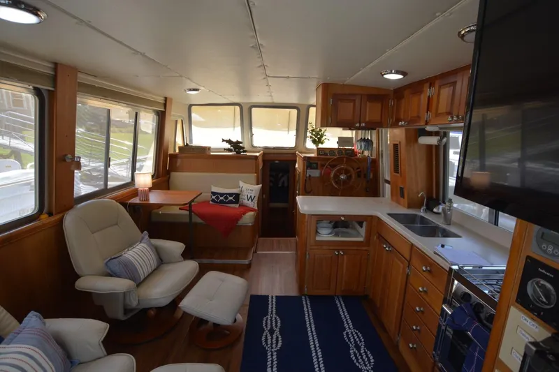 Slide: The Image of Interior of 2004 Mainship 400 Trawler with cozy seating and modern kitchen amenities. - 13