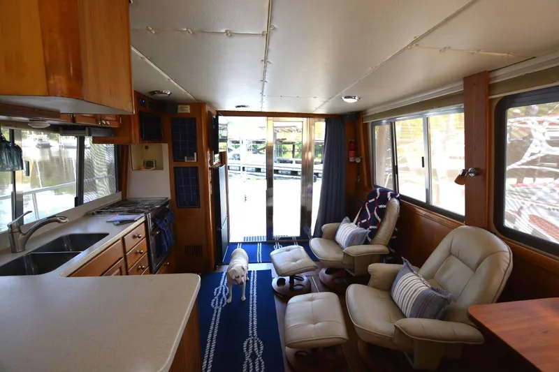 Slide: The Image of Interior of 2004 Mainship 400 Trawler with cozy seating and kitchen area. - 14