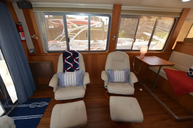 Slide: The Image of Interior of 2004 Mainship 400 Trawler with comfortable seating and nautical decor. - 15