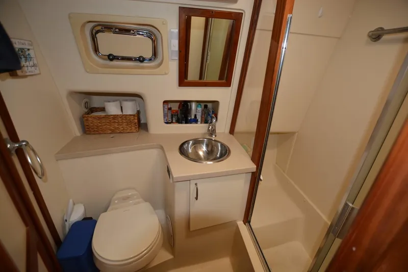 Slide: The Image of Bathroom interior of 2004 Mainship 400 Trawler with sink, toilet, and shower. - 18