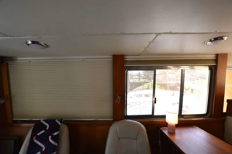 Slide: The Image of Interior of 2004 Mainship 400 Trawler with seating, table, and window view. - 20