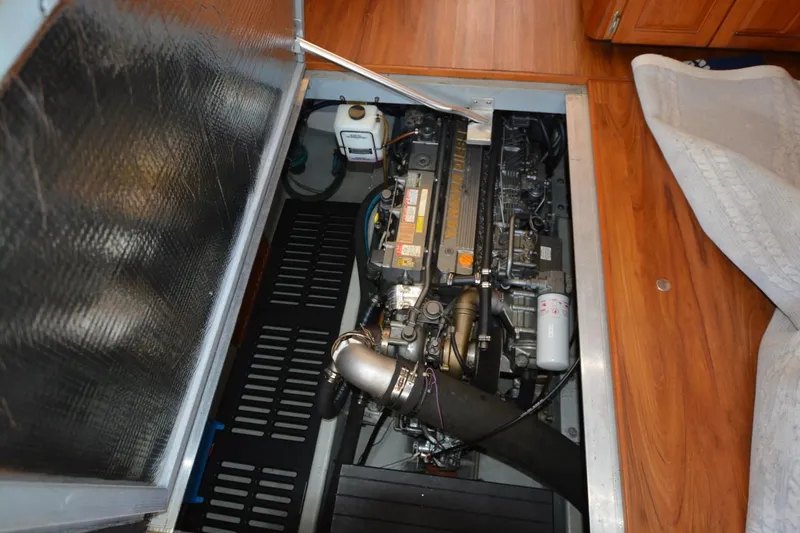 Slide: The Image of Engine compartment of a 2004 Mainship 400 Trawler, showcasing detailed mechanical components. - 25