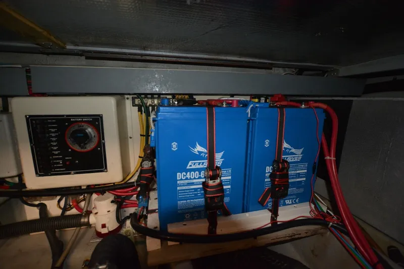 Slide: The Image of Battery compartment of 2004 Mainship 400 Trawler with blue DC400-6 batteries. - 27