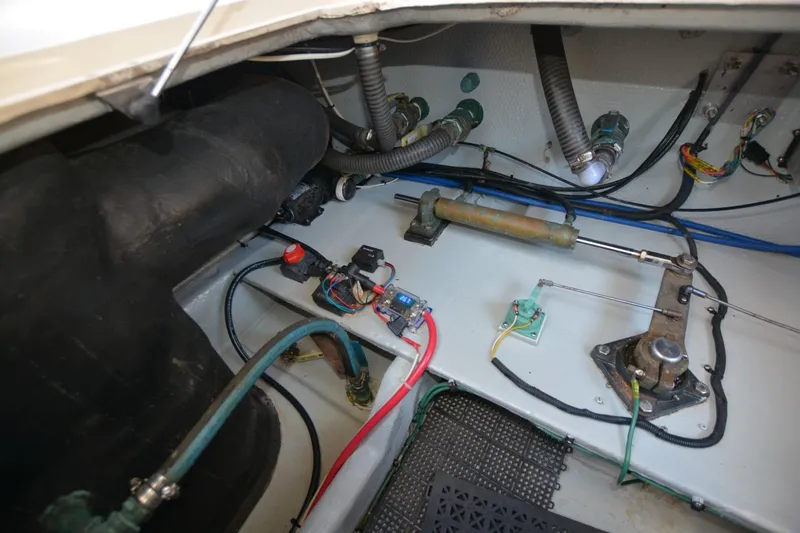 Slide: The Image of Engine compartment of a 2004 Mainship 400 Trawler, showcasing wiring and mechanical components. - 28