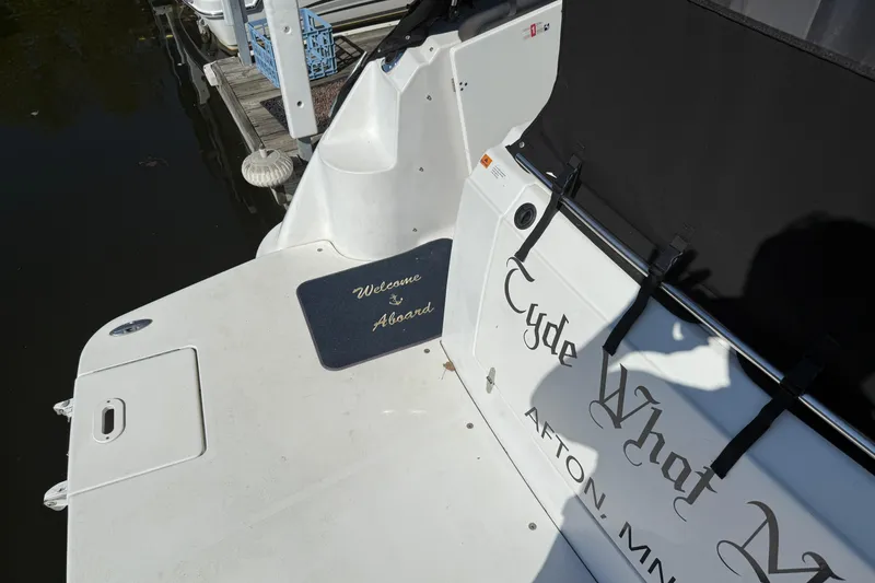 Slide: The Image of 2002 Four Winns 328 Vista boat with "Welcome Aboard" mat at dock. - 10