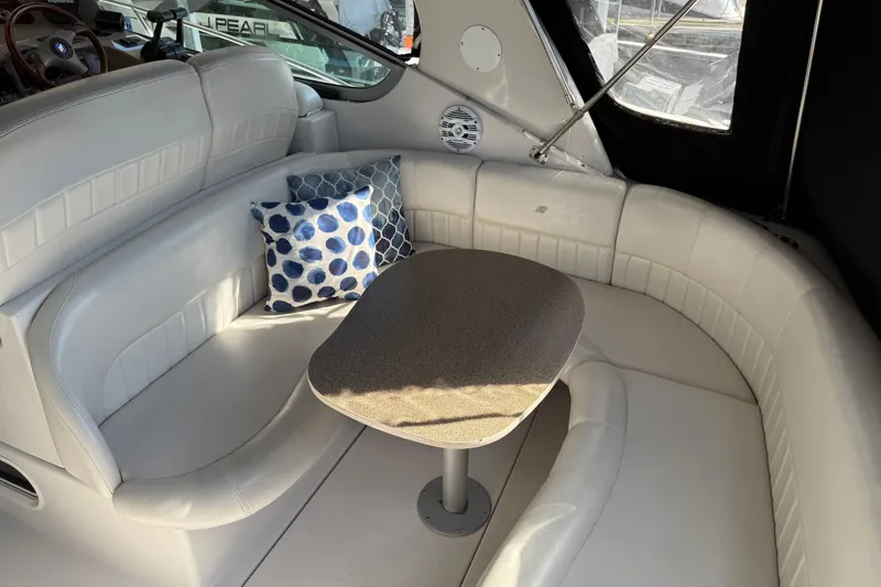 Slide: The Image of Interior of 2002 Four Winns 328 Vista boat with white seating and decorative pillows. - 13