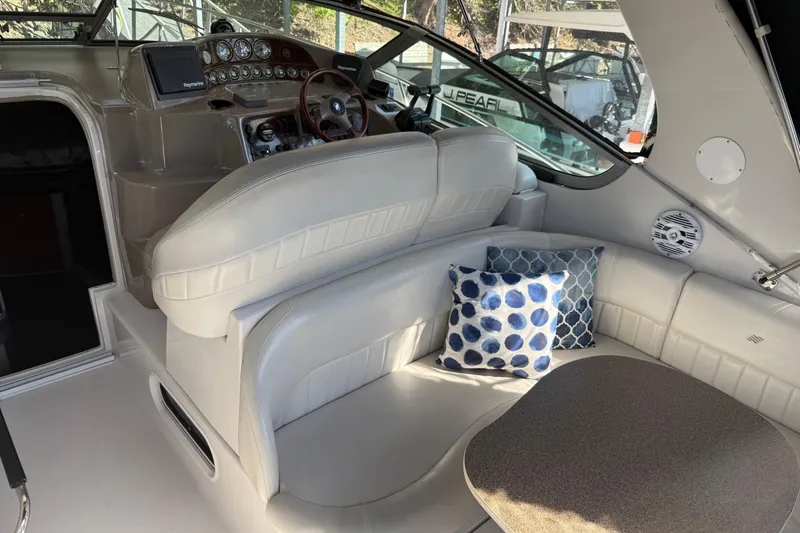 Slide: The Image of Interior of 2002 Four Winns 328 Vista boat with plush seating and decorative pillows. - 14