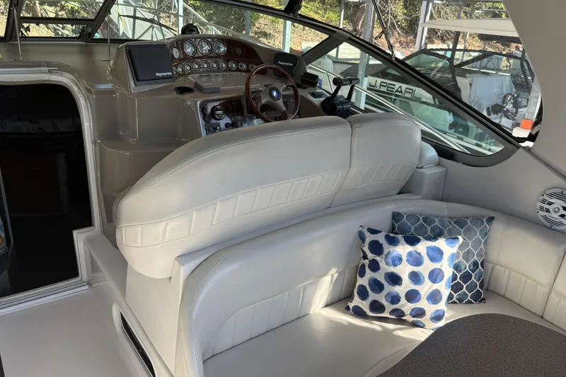 Slide: The Image of Interior of 2002 Four Winns 328 Vista boat with white seating and decorative pillows. - 15