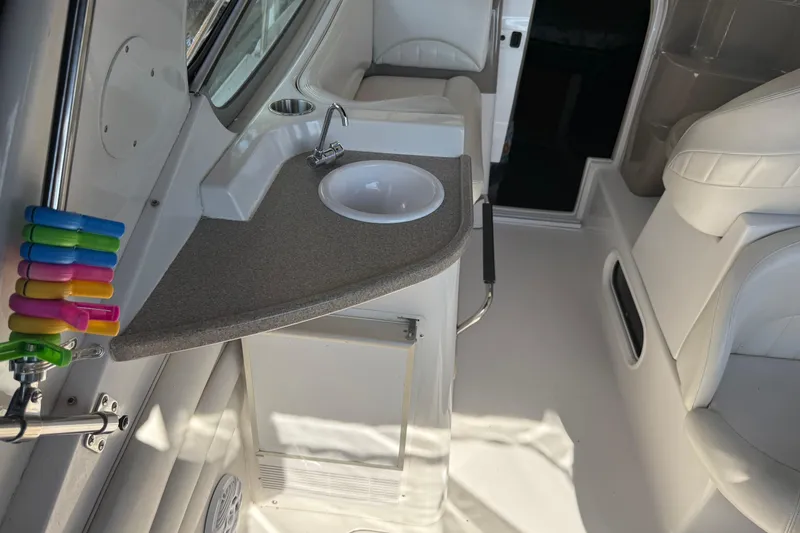 Slide: The Image of 2002 Four Winns 328 Vista boat interior with sink and colorful clips. - 16