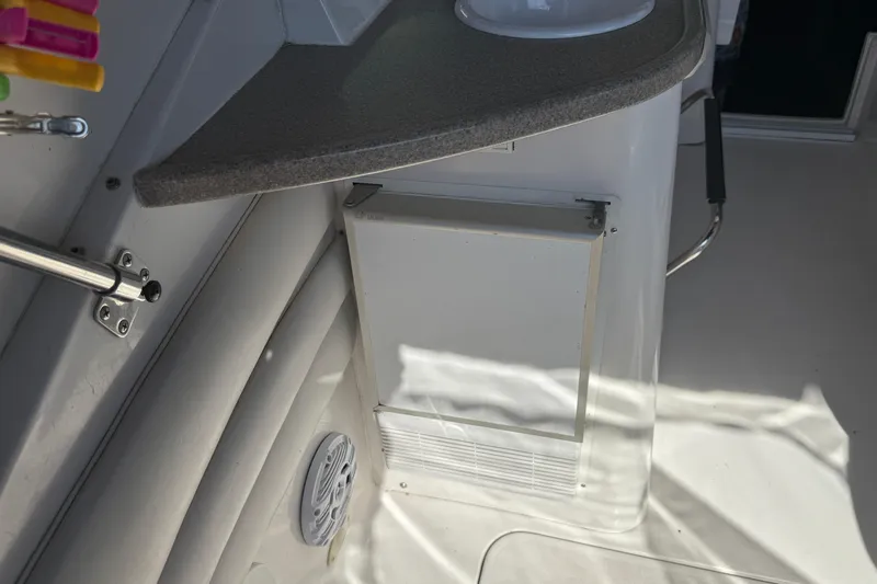 Slide: The Image of 2002 Four Winns 328 Vista boat interior with countertop and storage compartment. - 17
