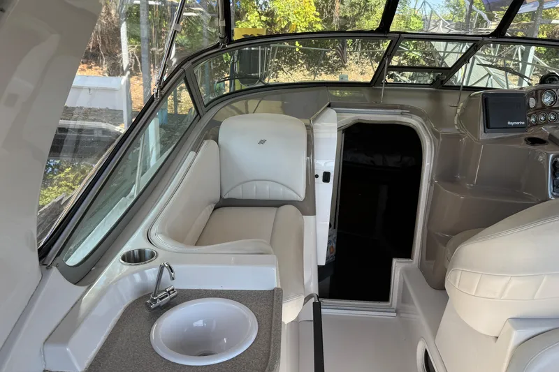 Slide: The Image of 2002 Four Winns 328 Vista boat interior with seating, sink, and navigation equipment. - 20