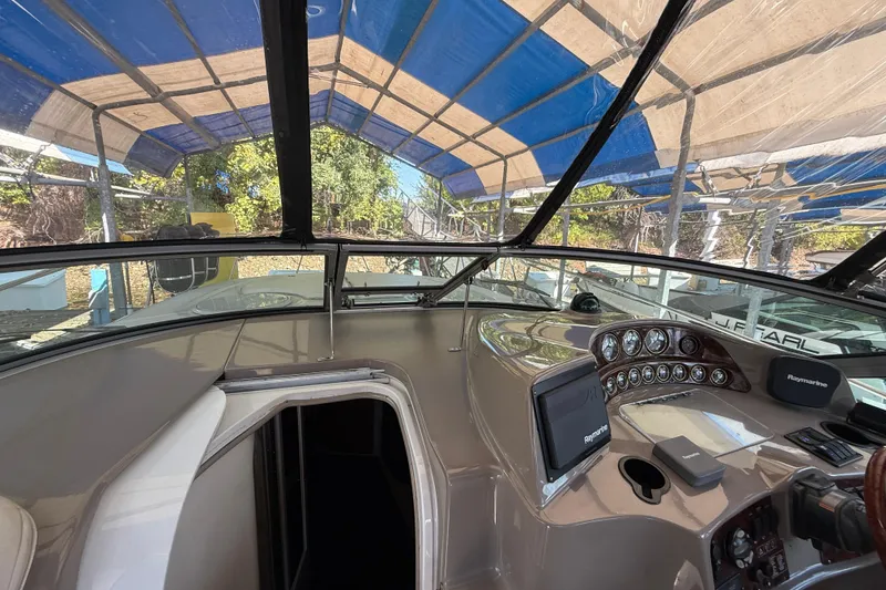Slide: The Image of 2002 Four Winns 328 Vista boat cockpit with Raymarine navigation system under a canopy. - 21